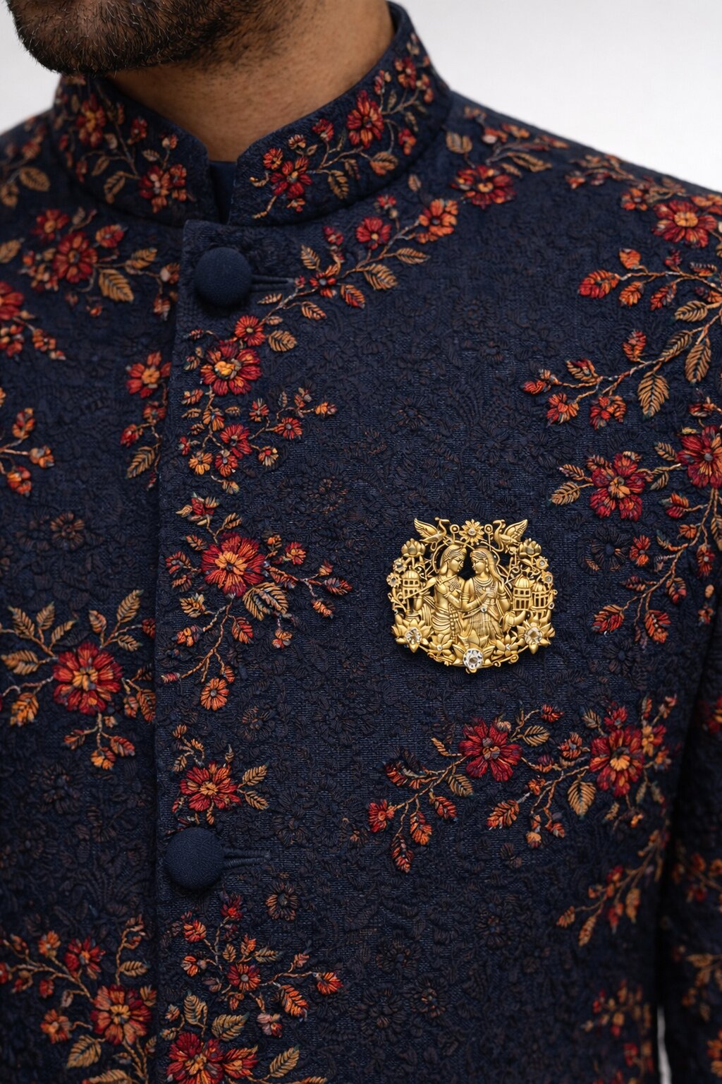 Gold-tone Radha Krishna brooch featuring intricate floral motifs, peacocks, lotus flowers, and sparkling crystal accents, ideal for weddings and festive wear.