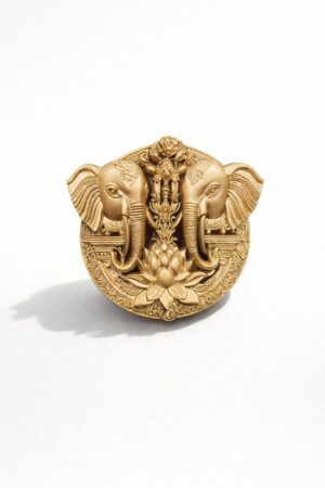 Gold-tone twin elephant brooch featuring a lotus flower motif and intricate traditional detailing, ideal for weddings and festive occasions.