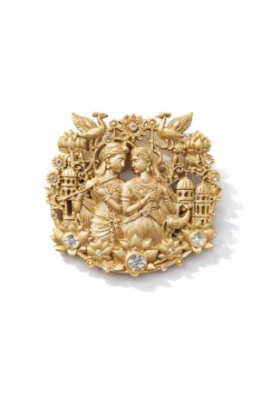 Gold-tone Radha Krishna brooch featuring intricate floral motifs, peacocks, lotus flowers, and sparkling crystal accents, ideal for weddings and festive wear.