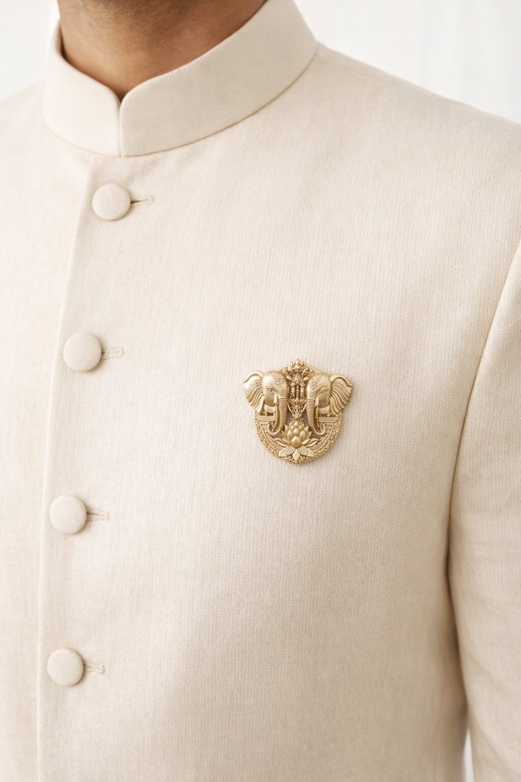 Gold-tone twin elephant brooch featuring a lotus flower motif and intricate traditional detailing, ideal for weddings and festive occasions.