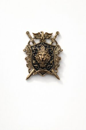 Antique gold lion crest shield brooch featuring a crowned lion emblem, black enamel background, crossed swords, and intricate royal detailing.