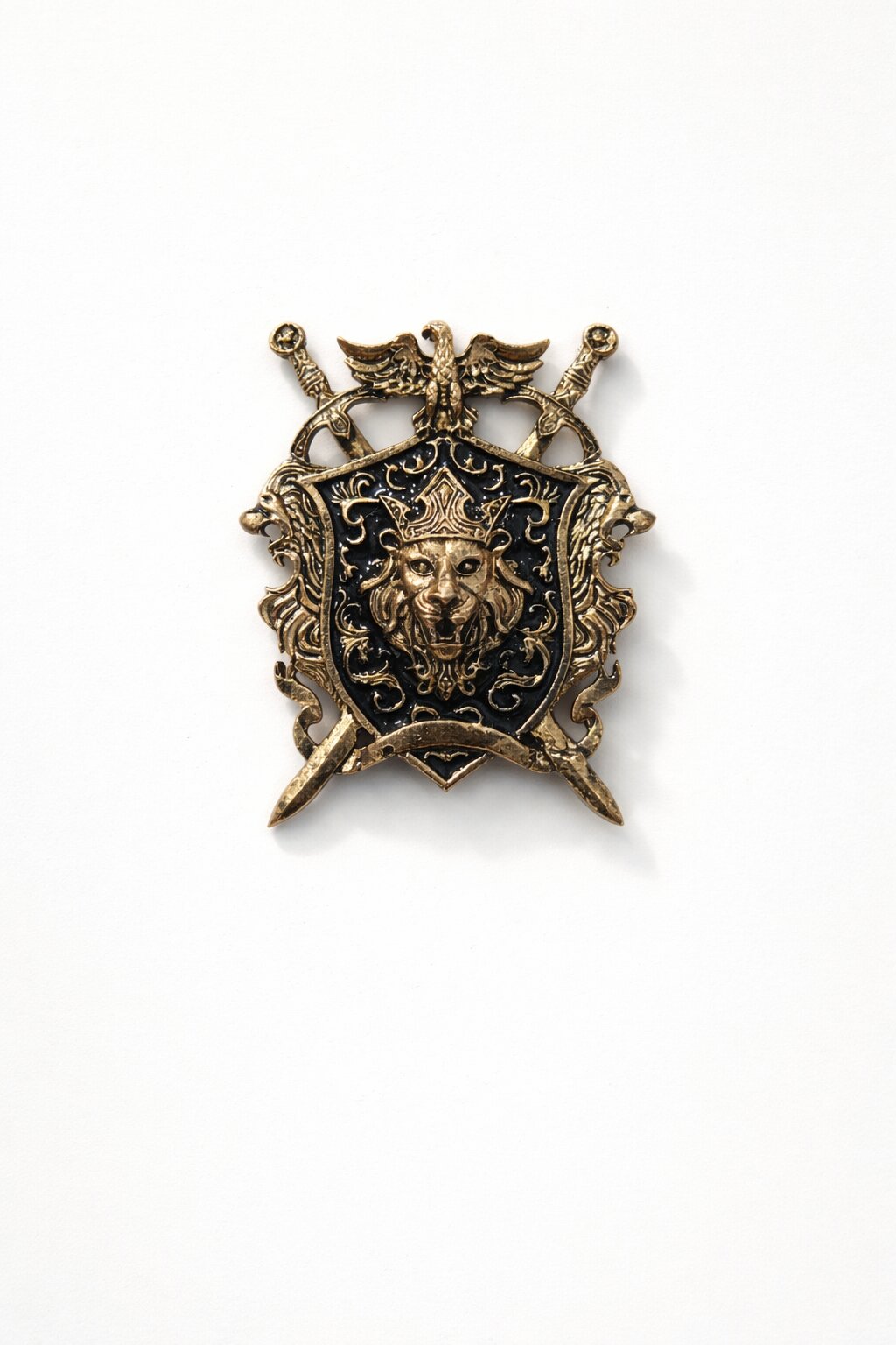 Antique gold lion crest shield brooch featuring a crowned lion emblem, black enamel background, crossed swords, and intricate royal detailing.