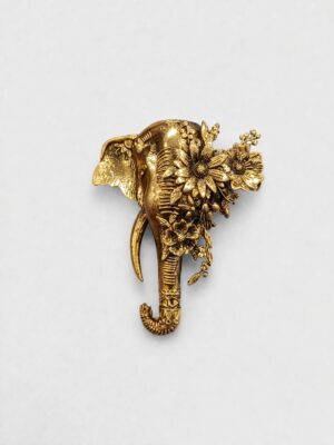 Antique gold elephant brooch featuring intricate floral detailing and elegant botanical motifs, perfect for weddings and festive occasions.