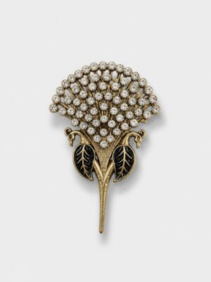 Vintage gold floral brooch featuring sparkling crystal stones and black enamel leaf accents, suitable for formal and festive wear.