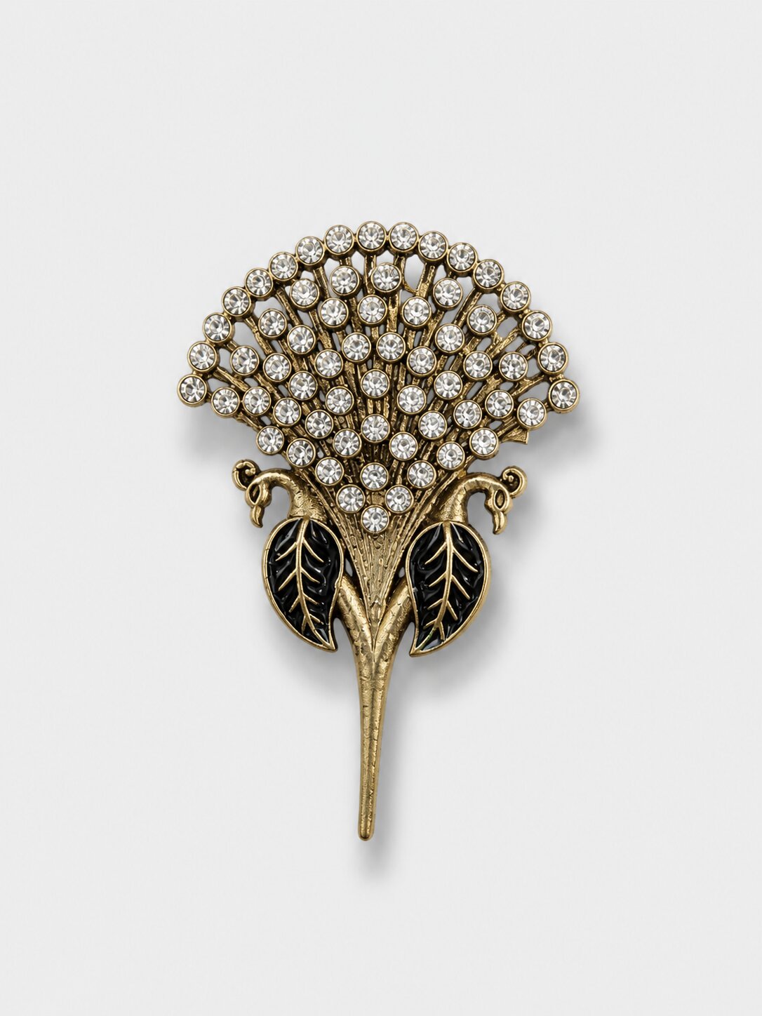 Vintage gold floral brooch featuring sparkling crystal stones and black enamel leaf accents, suitable for formal and festive wear.
