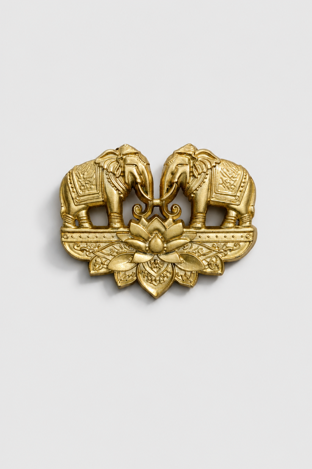 Gold-tone twin elephant brooch featuring two facing elephants with a lotus flower centerpiece and intricate traditional detailing, perfect for weddings and festive wear.