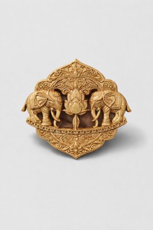 Antique gold twin elephant brooch featuring a central lotus motif and intricate traditional ornamental detailing, ideal for weddings and festive wear.