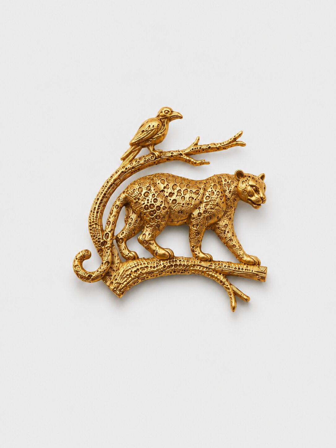 Gold finish leopard and bird brooch featuring intricate detailing on a branch design, suitable for wedding and formal wear.