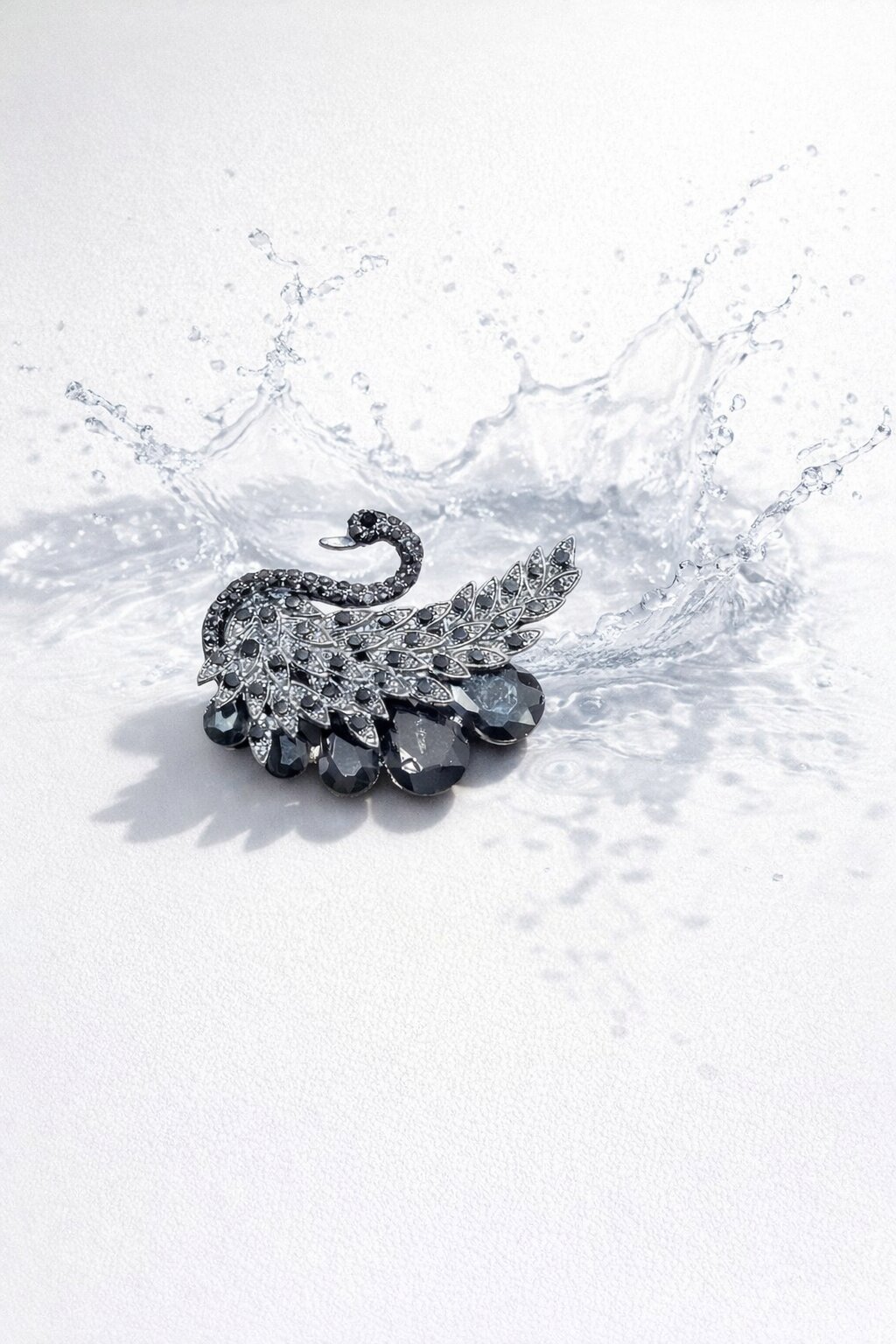 Black crystal swan brooch with intricate feather detailing and dark faceted gemstone accents in a gunmetal-tone finish.