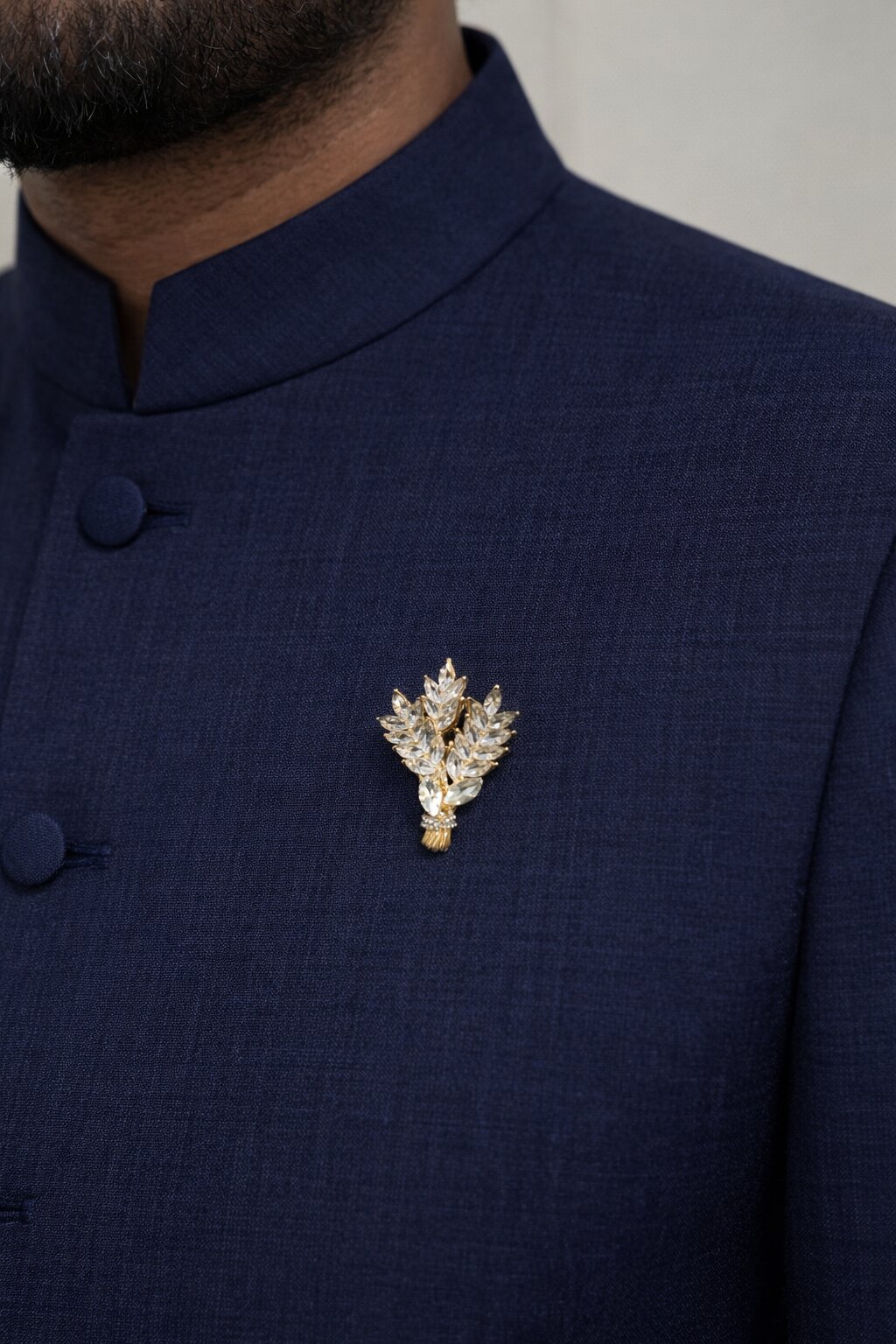 Gold-tone wheat sheaf brooch adorned with sparkling marquise-cut clear crystals in an elegant botanical design.