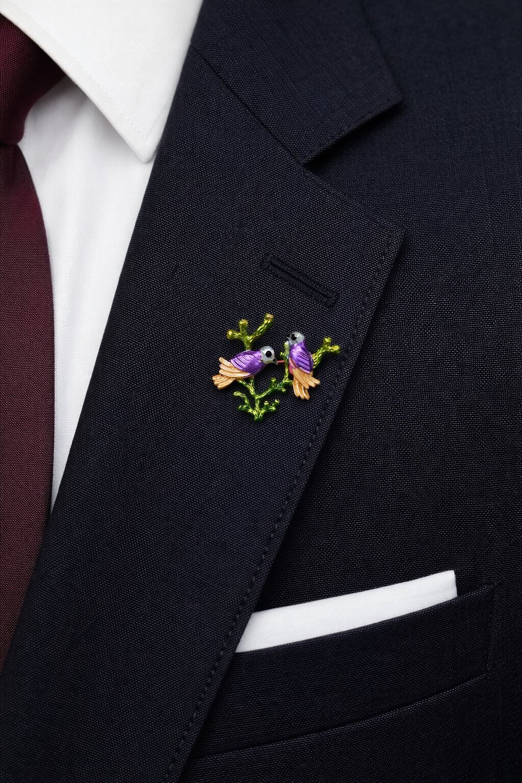 Enamel brooch with two purple birds perched on a green branch with gold-tone details.