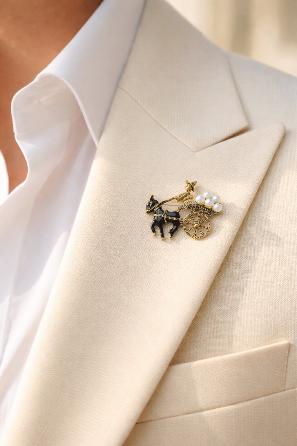 Antique gold-tone horse cart brooch with black enamel horse and pearl cargo details.