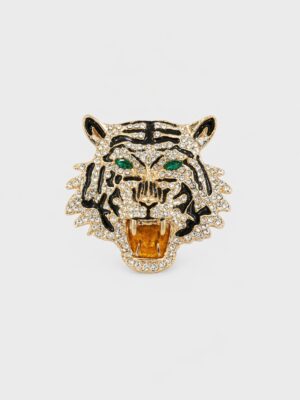 Gold-tone roaring tiger brooch with clear crystals, black enamel stripes, green eyes, and amber-colored mouth detail.