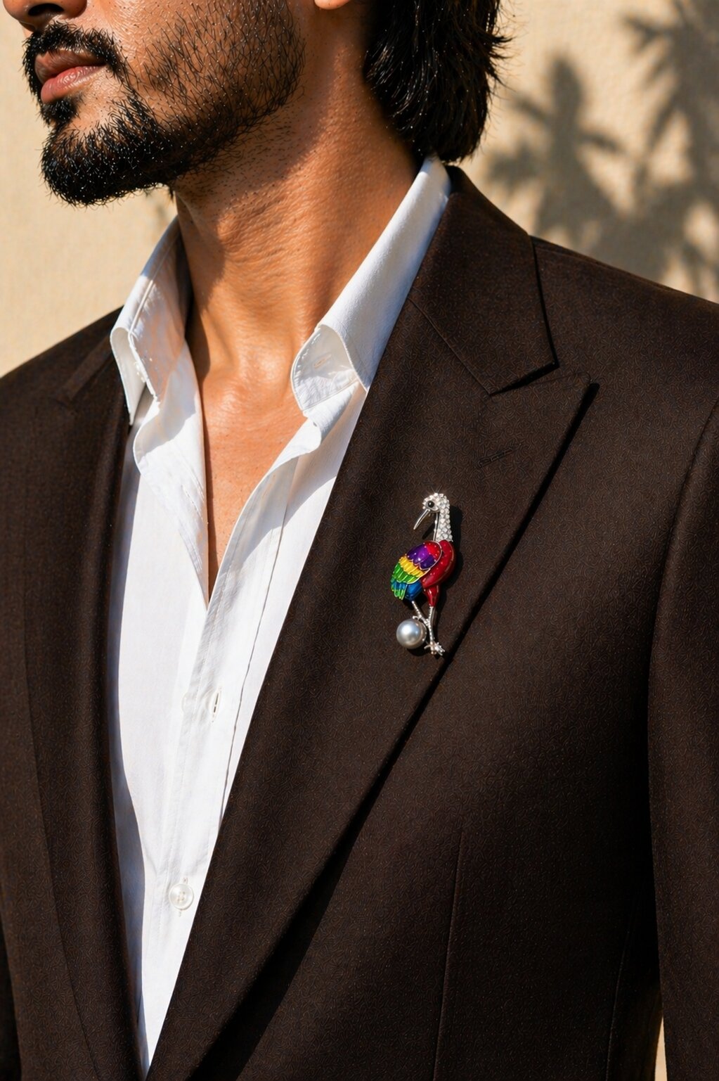 Colorful crane brooch with rainbow enamel wings, crystal detailing, and a grey pearl accent in a silver-tone setting.