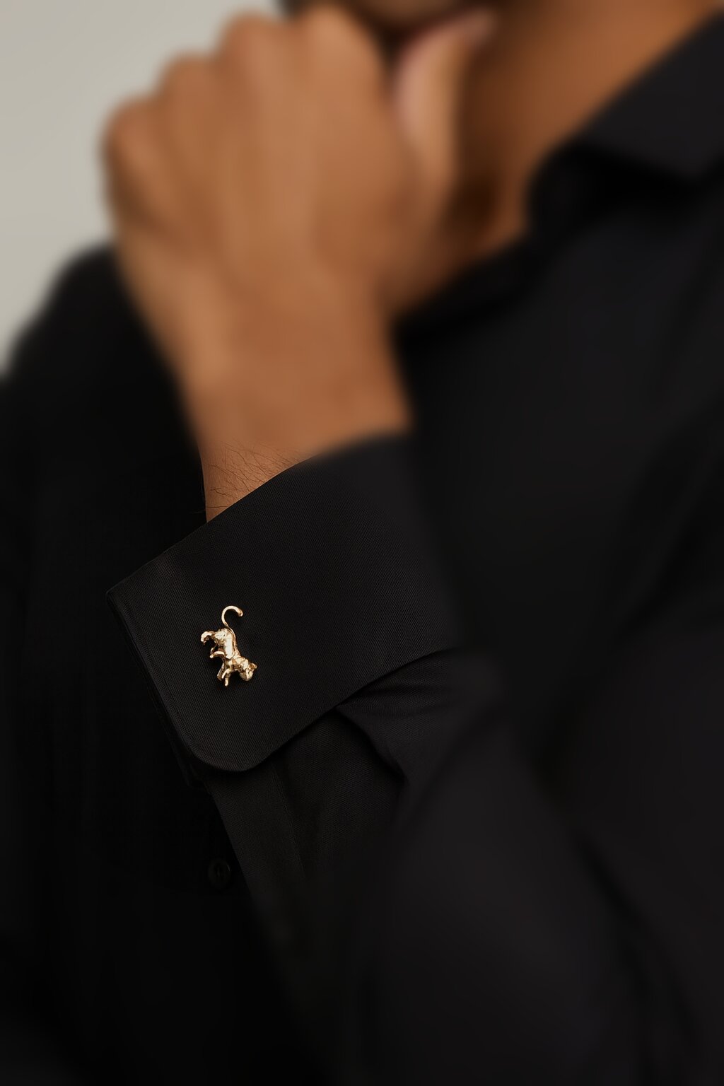 Gold-tone panther shaped cufflinks with polished finish for men's formal wear.