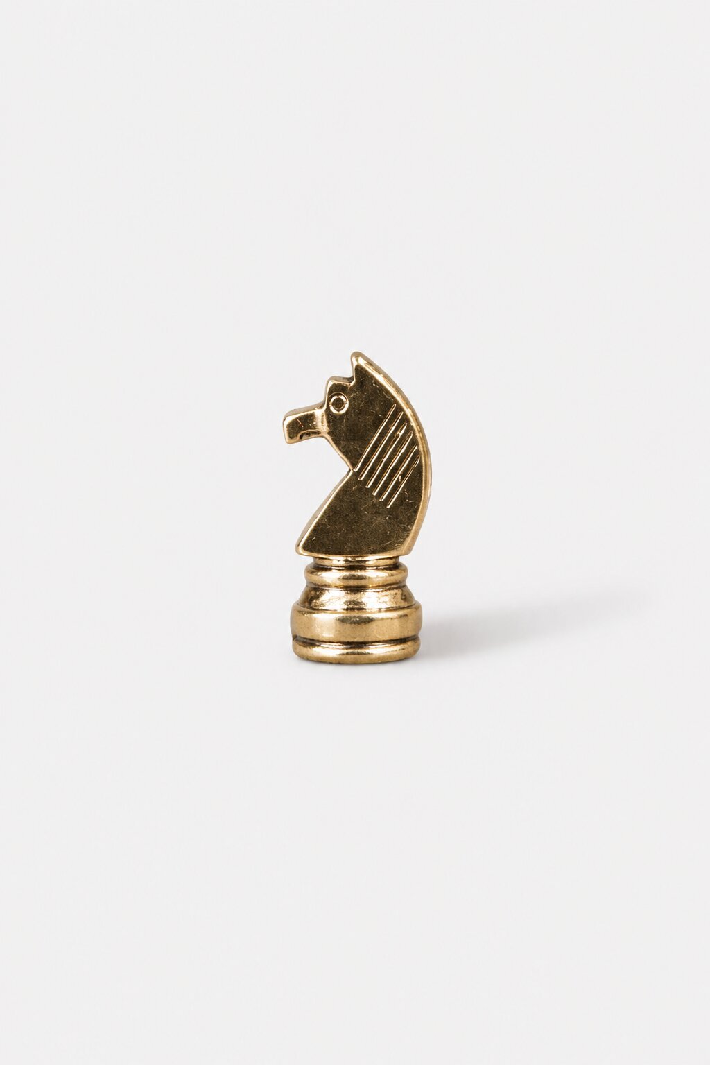 Gold knight chess piece brooch with polished metallic finish and detailed design.