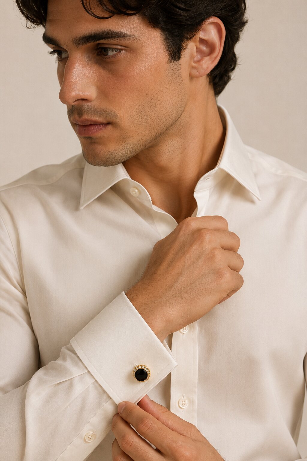 Round gold cufflinks with black center stone and crystal-studded border for men's formal accessories.