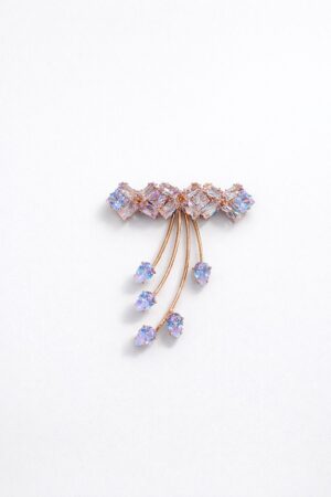 Rose gold crystal brooch with iridescent geometric stones and cascading teardrop crystal accents in a modern elegant design.