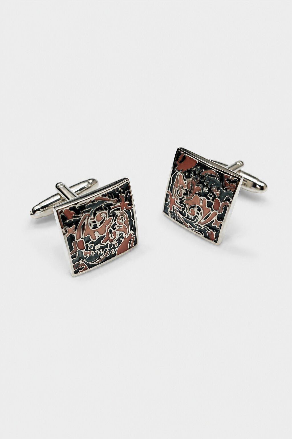 Square silver-tone cufflinks with intricate multicolor enamel artwork in black, red, and ivory shades.