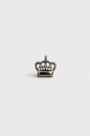 Silver crown brooch with crystal stones and polished metallic finish.