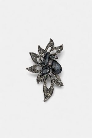 Floral crystal brooch with smoky black gemstones, sparkling crystal accents, and intricate gunmetal-tone leaf detailing.