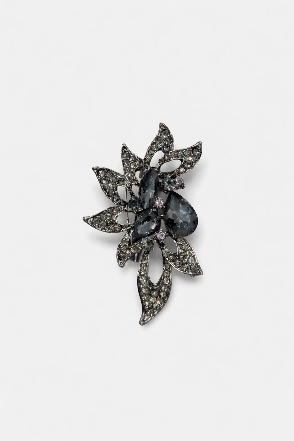 Floral crystal brooch with smoky black gemstones, sparkling crystal accents, and intricate gunmetal-tone leaf detailing.