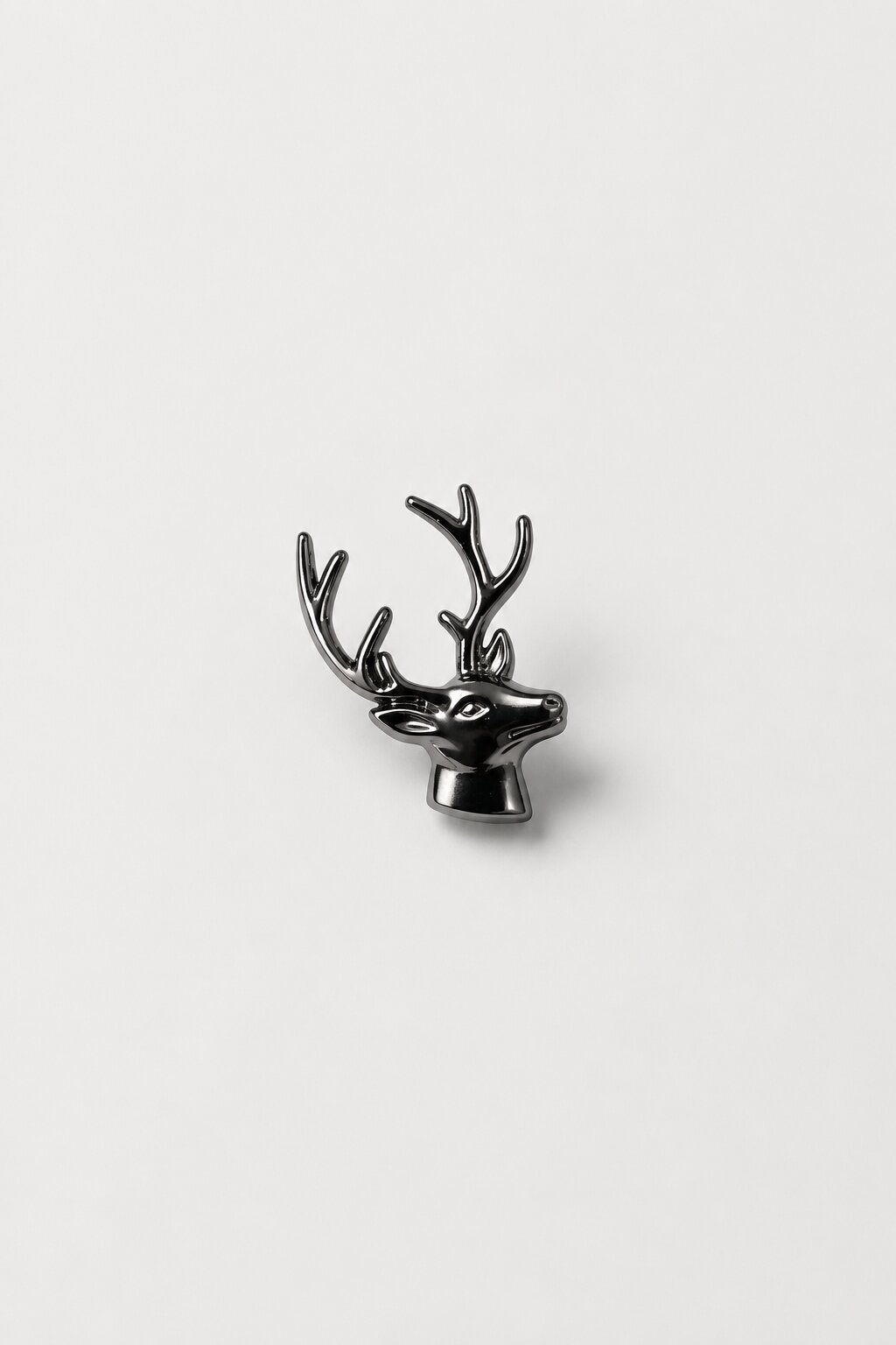 Black metallic stag head brooch with detailed antlers and polished finish.