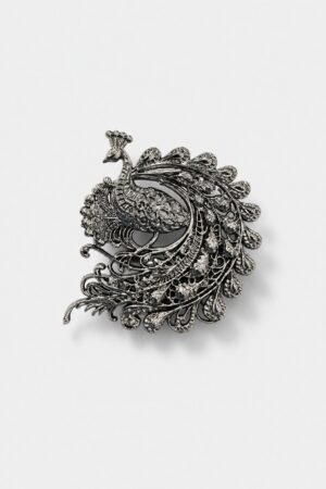 Antique silver peacock brooch with intricate filigree detailing and ornate feather design inspired by royal Indian heritage.