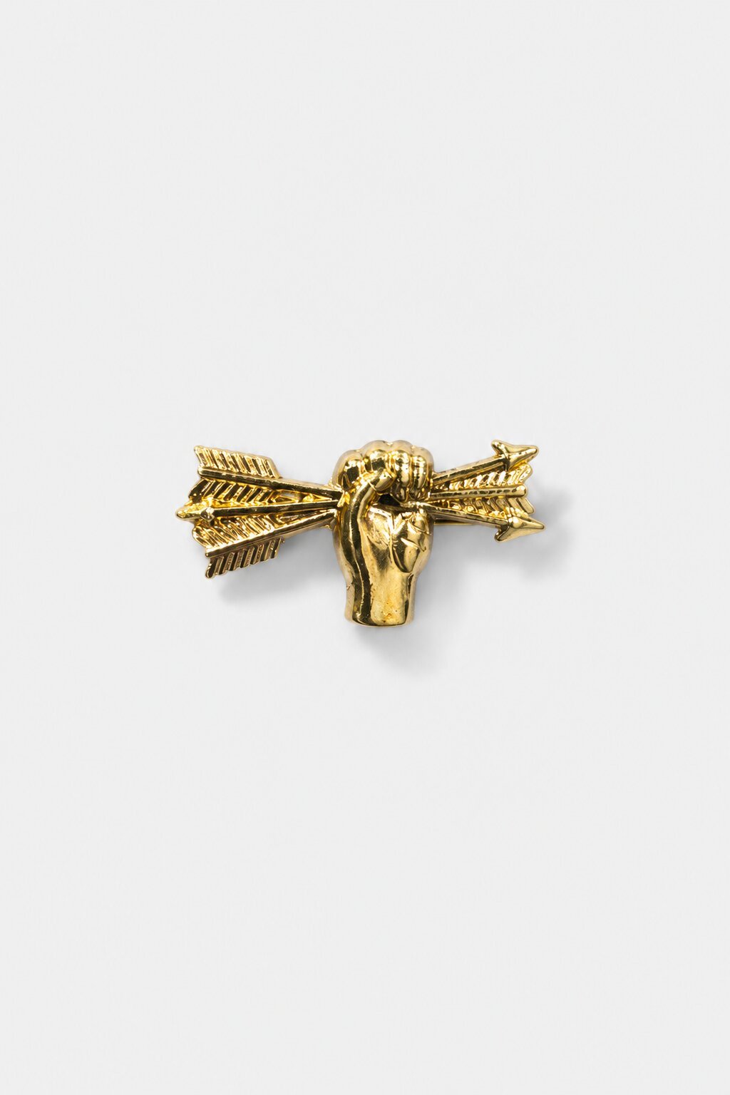 Gold-tone collar brooch featuring a hand holding an arrow with intricate decorative detailing.