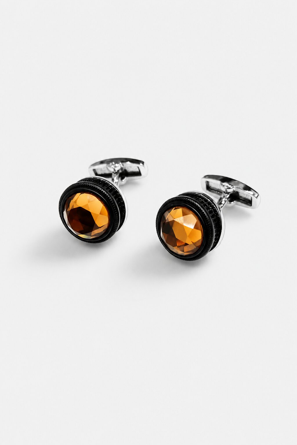 Round silver-tone cufflinks with faceted brown crystal stones for men's formal shirts.