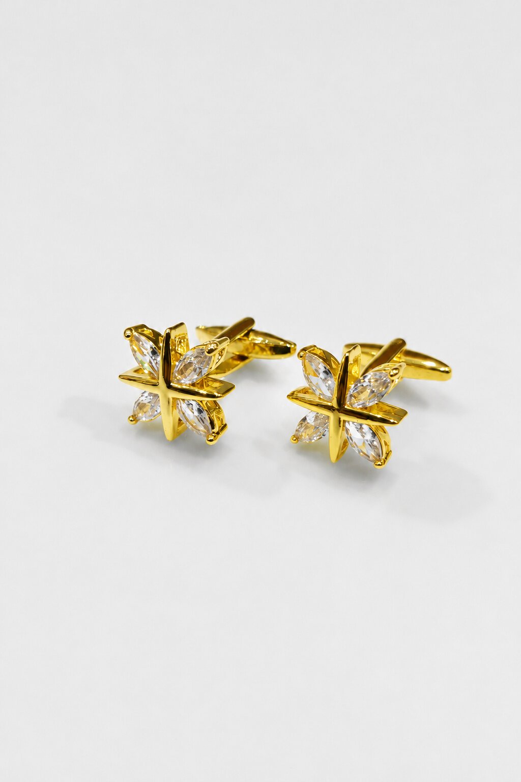 Gold star-shaped cufflinks with clear crystal accents for men's formal shirts.