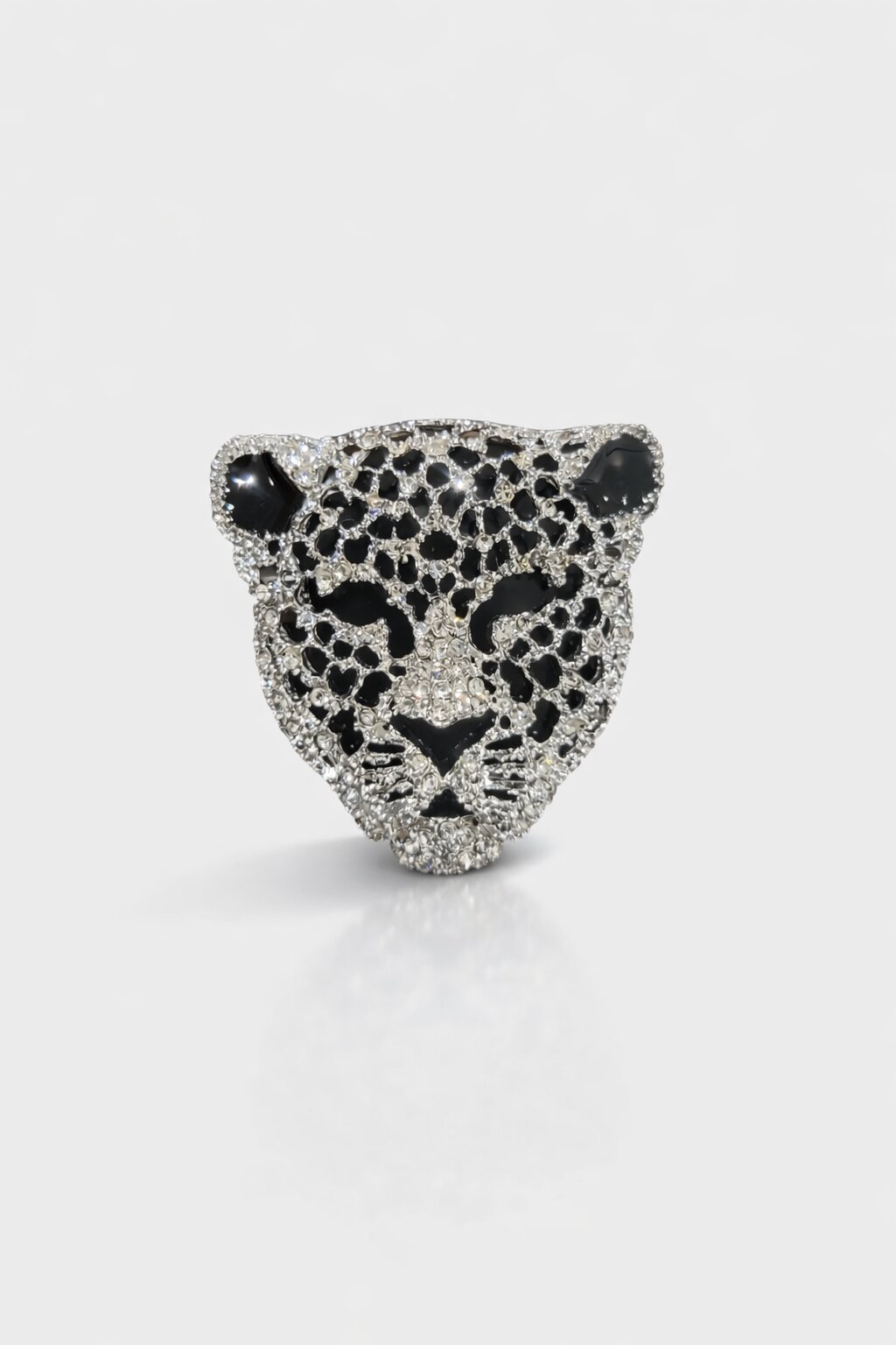 Leopard face brooch with clear crystals, black enamel detailing, and silver-tone finish.