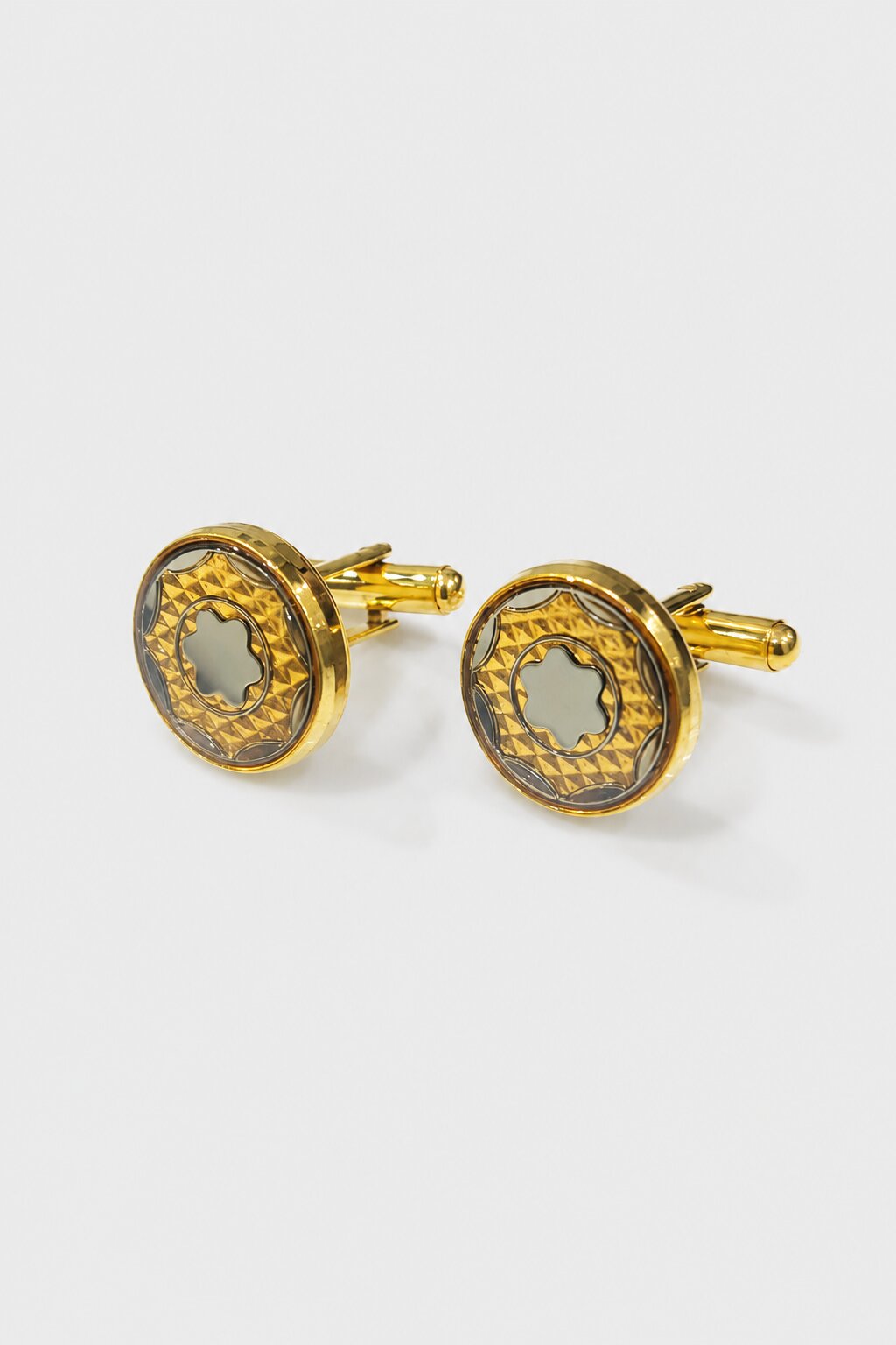 Gold round cufflinks with engraved geometric pattern and silver-tone floral center design for men's formal shirts.