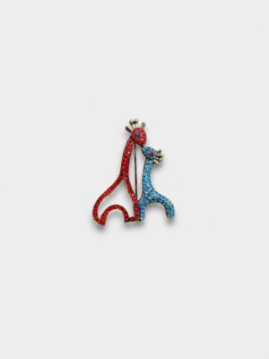 Colorful giraffe duo brooch featuring red and blue crystal embellishments in an elegant gold-tone finish.