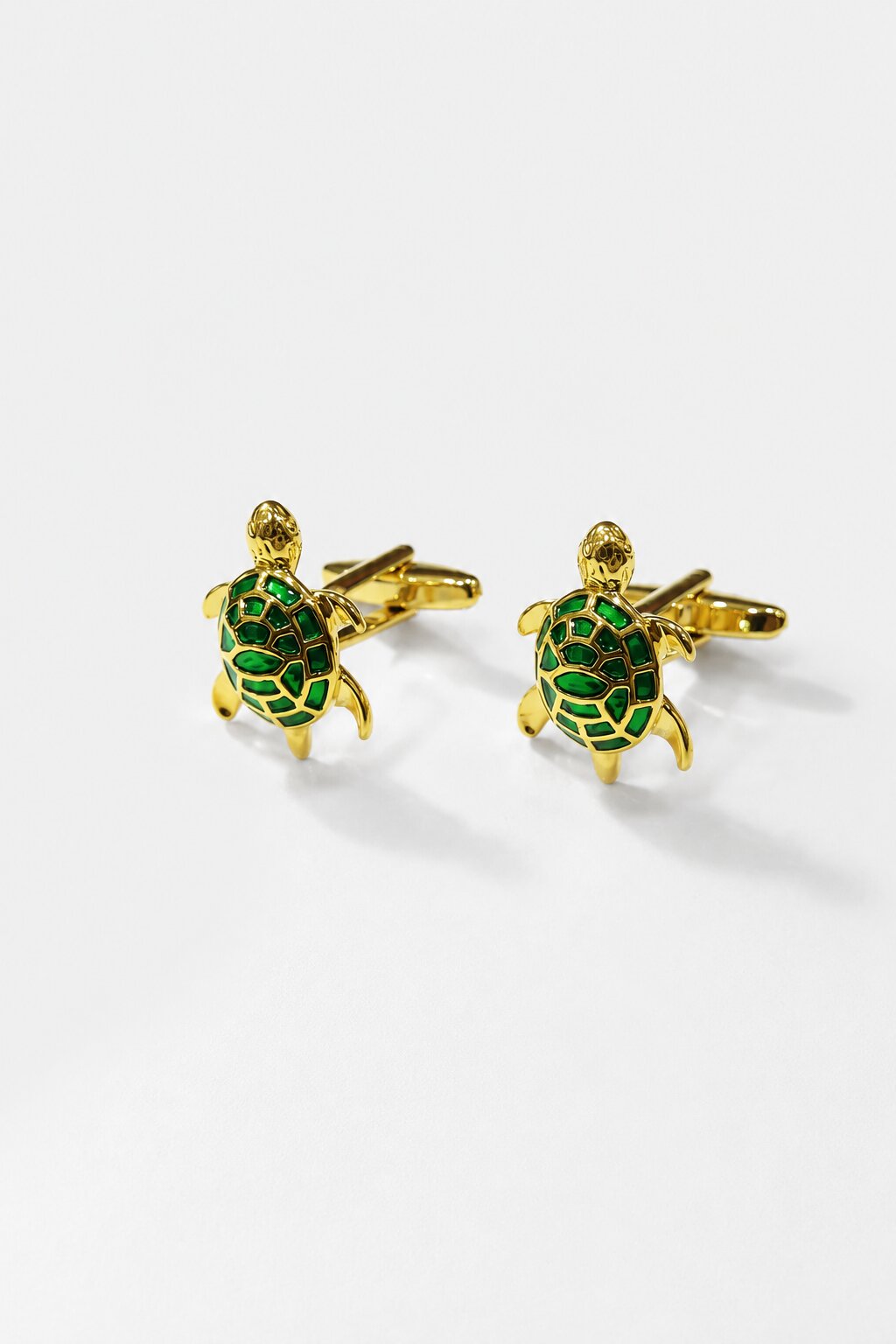 Gold turtle cufflinks with green enamel shell detailing for men's formal shirts.