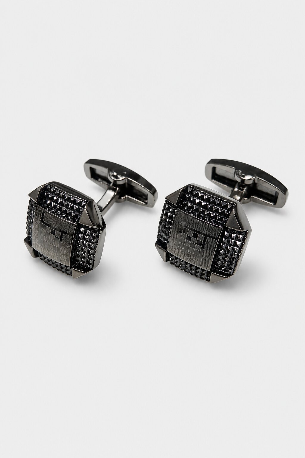Gunmetal square cufflinks with textured geometric detailing and modern architectural design.