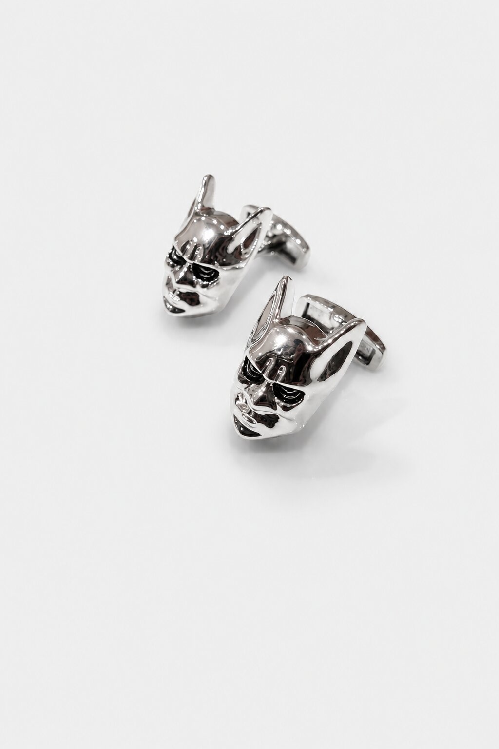Silver superhero mask cufflinks with polished metallic finish for men's formal attire.