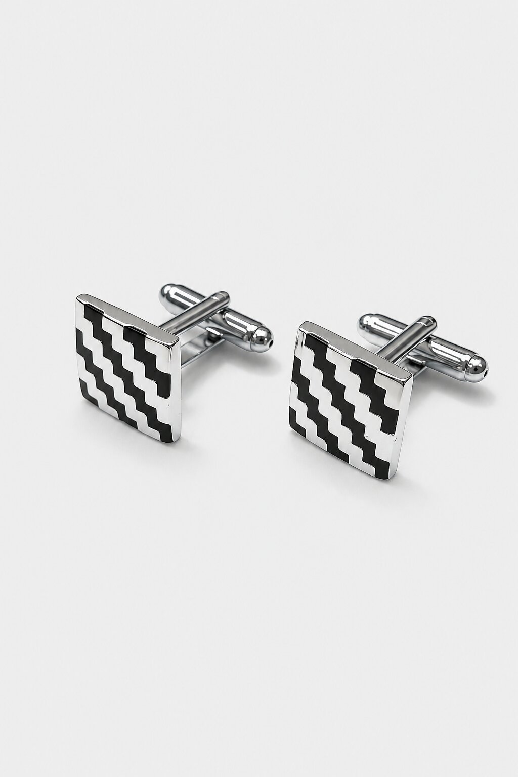 Square silver-tone cufflinks with black and white geometric zigzag pattern for men's formal shirts.