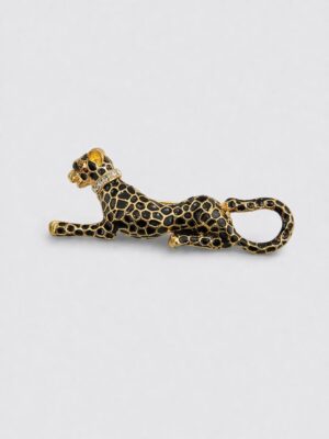 Gold-tone reclining leopard brooch with black enamel spots and crystal collar detail.