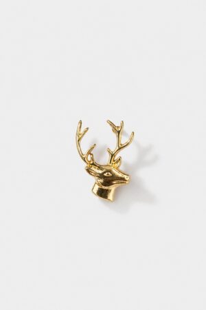 Gold-tone stag head brooch with detailed antlers and polished metallic finish.