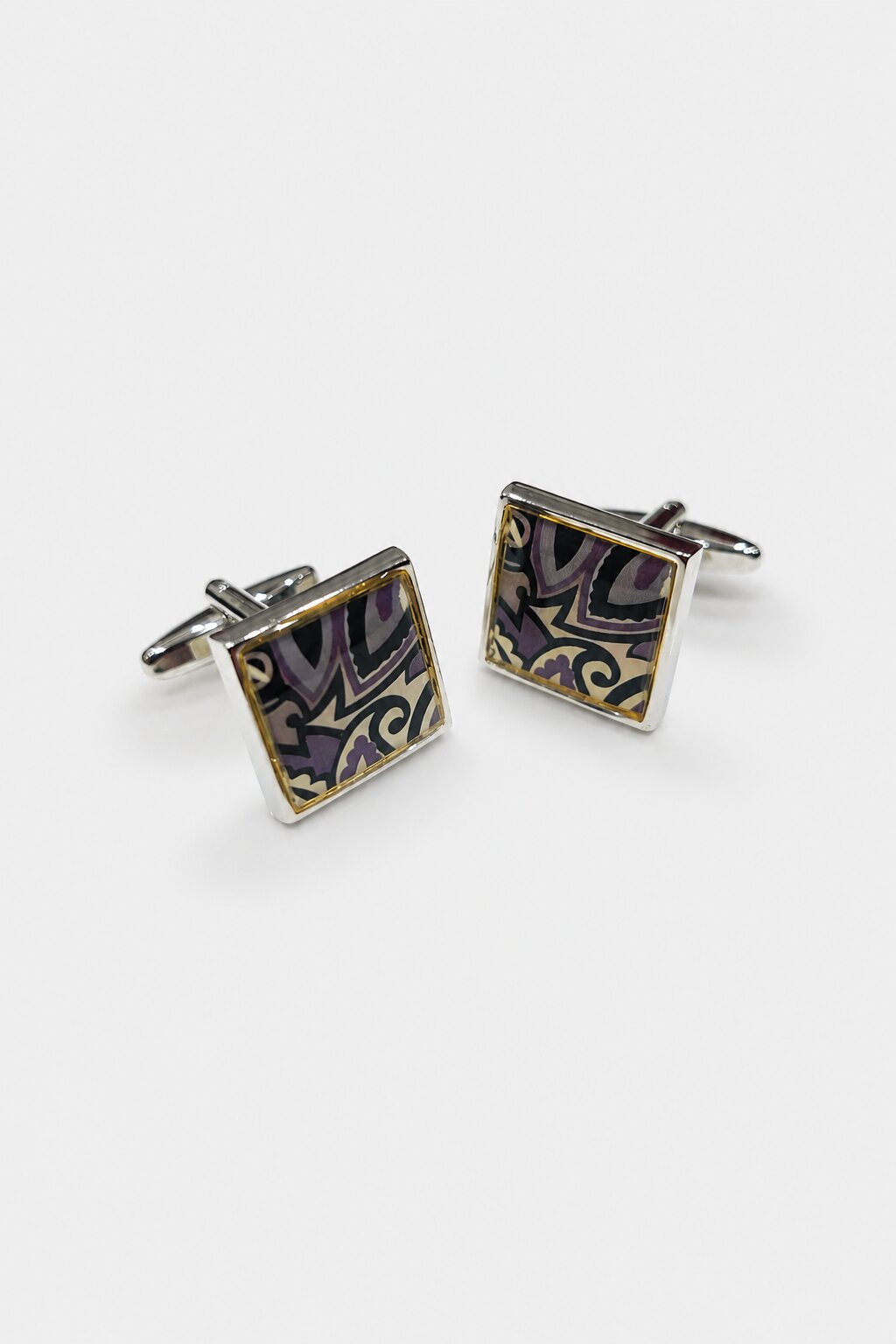 Square silver-tone cufflinks with abstract purple, black, and gold decorative pattern for men's formal shirts.