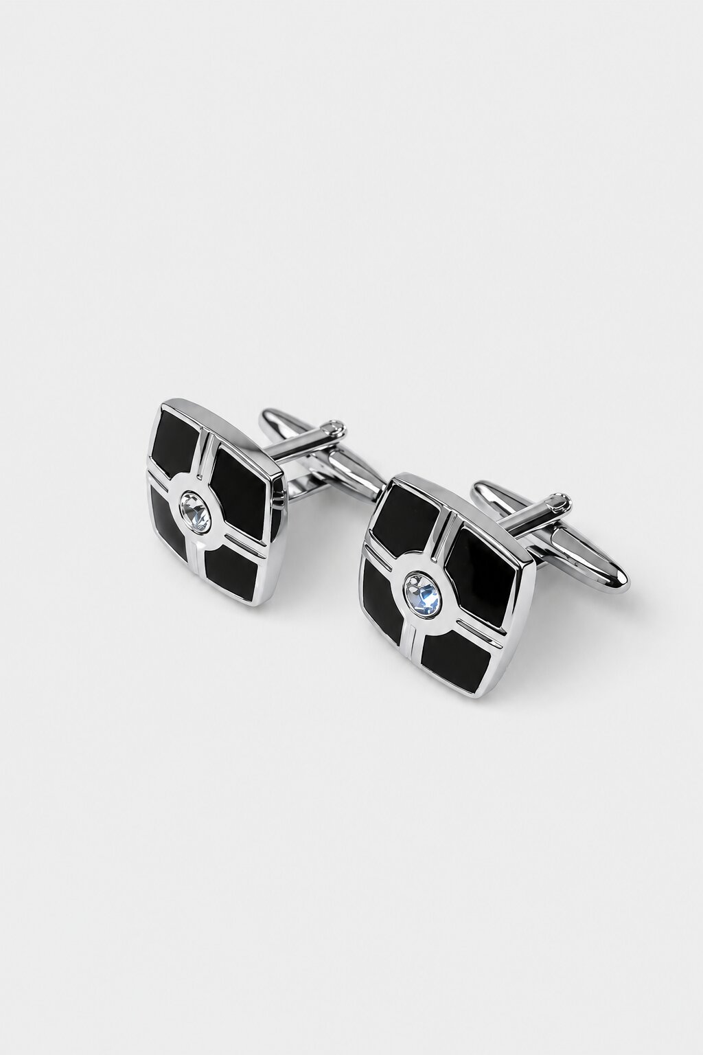 Square silver-tone cufflinks with black textured panels and crystal center detail.