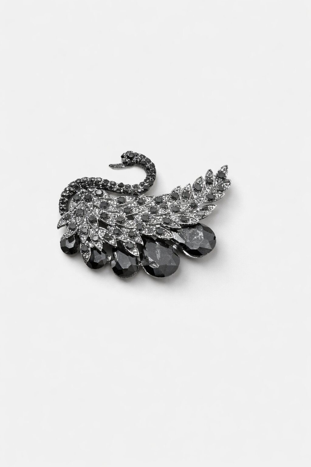 Black crystal swan brooch with intricate feather detailing and dark faceted gemstone accents in a gunmetal-tone finish.