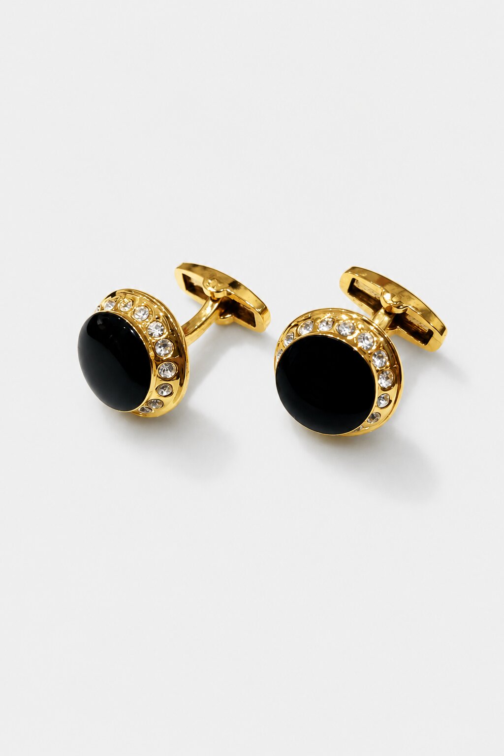 Round gold cufflinks with black center stone and crystal-studded border for men's formal accessories.