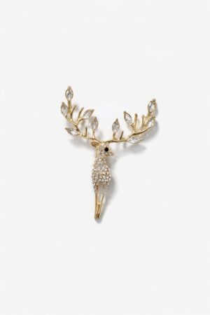 Gold-tone stag brooch embellished with clear crystals and crystal-accented antlers in an elegant luxury design.