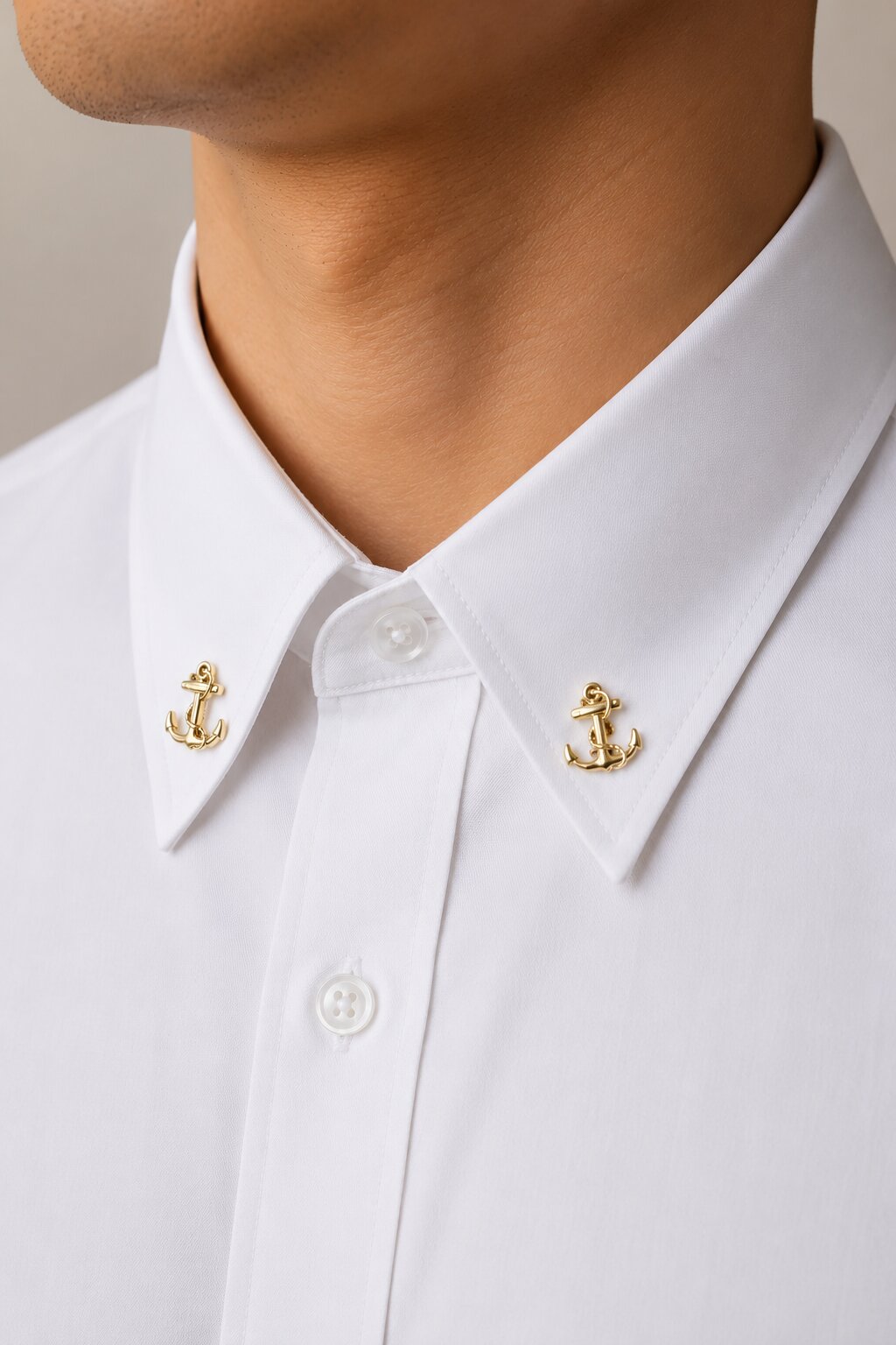 Gold nautical anchor brooch with rope detailing and polished premium finish.