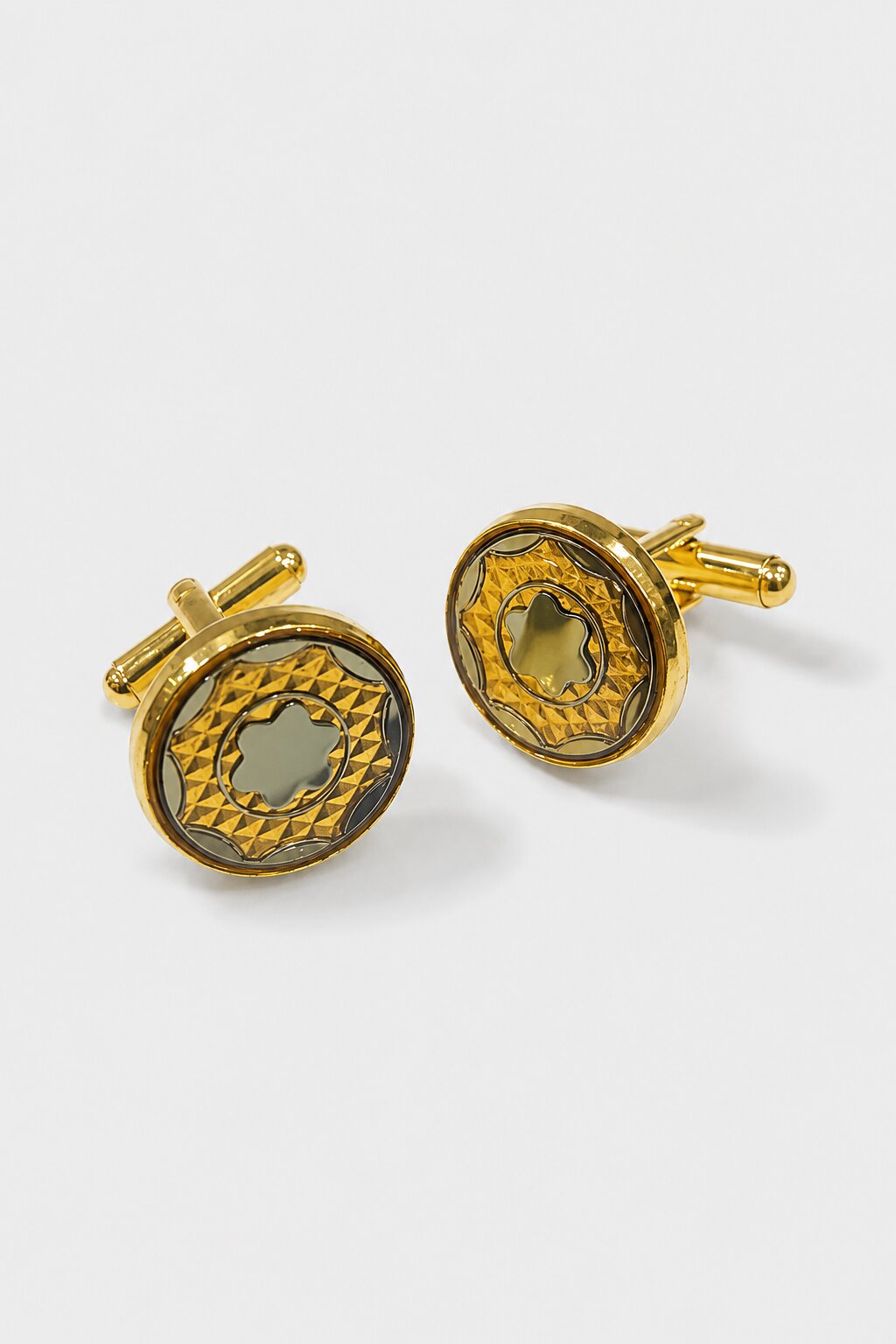 Gold round cufflinks with engraved geometric pattern and silver-tone floral center design for men's formal shirts.