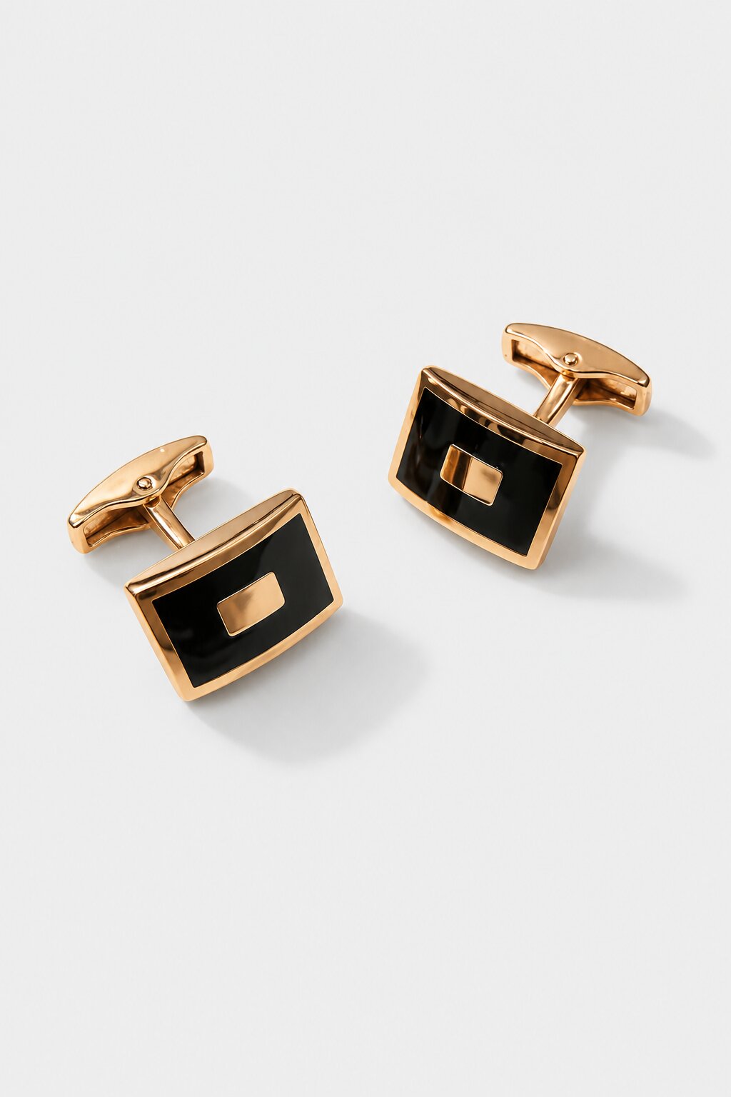 Gold rectangular cufflinks with black enamel center panel for men's formal shirts.