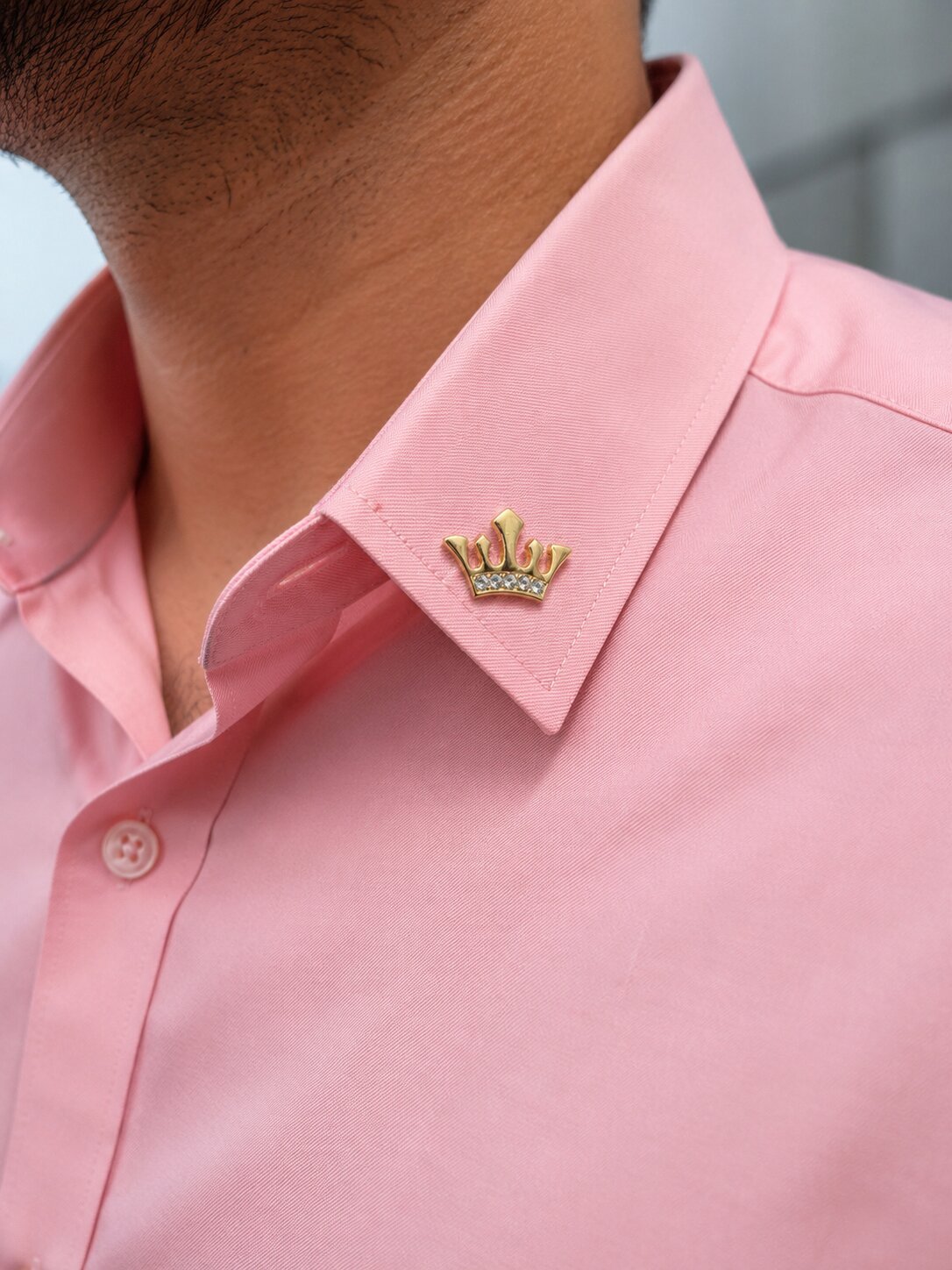 Gold crown brooch with crystal embellishments and polished premium finish.
