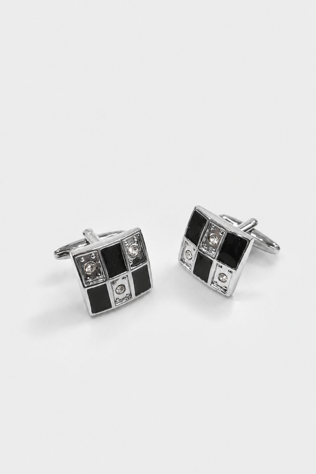 Silver square cufflinks with black geometric enamel design and crystal accents for men's formal shirts.